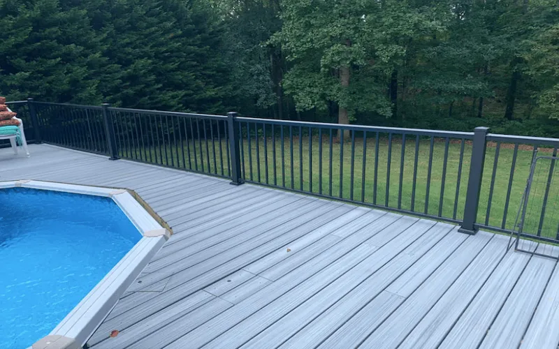 new-composite-deck-with-black-aluminum-fence-around-pool